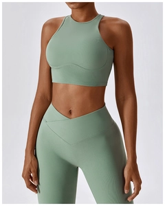 Detailed close-up of ribbed texture and hollow-out back design on sage green sports bra