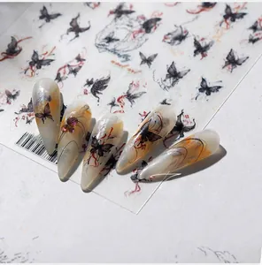 Macro detail of black ink butterfly nail art stickers with red string design