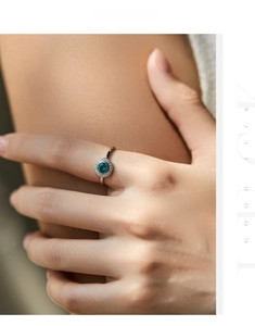 Detailed view of s925 silver ring featuring a teal blue center stone and pavé diamonds