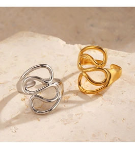 Close-up of gold and silver spiral rings on stone base with soft shadow lighting