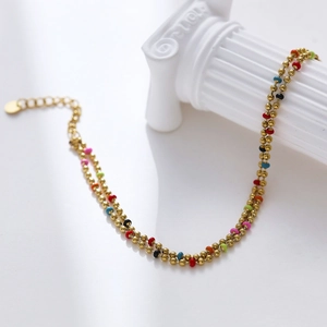 Detail of double-layer golden bead bracelet with colorful zircon accents and extender