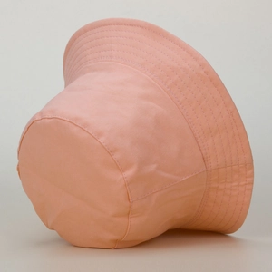 Detailed view of pink cotton bucket hat showing reinforced brim stitching and fabric texture