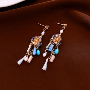 Detailed view of ethnic style tassel earrings with colorful beads and metal chains