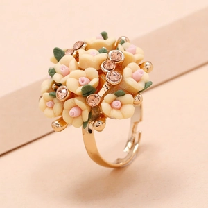 Floral cluster open ring featuring yellow and pink flowers with green leaves and crystals