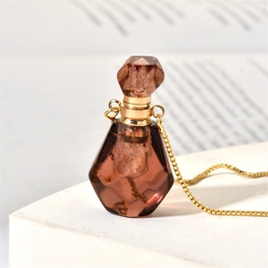 Macro shot of the brown gemstone perfume bottle pendant with a golden chain link