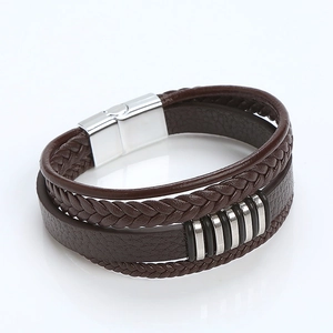 Detail of multi-layer brown braided leather bracelet with silver magnetic metal clasp