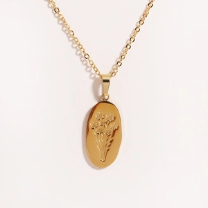 Detailed view of an oval gold rose pendant with floral engraving on a titanium steel chain