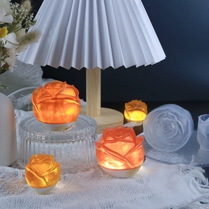 DIY rose flower silicone mold and glowing LED floral ornaments on a cozy desk setup