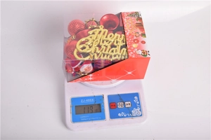 Detail showing weight of the 32-piece blue Christmas ornament set on a digital scale