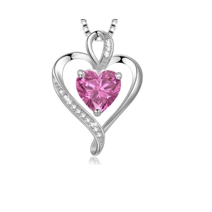 Polished silver heart pendant necklace with heart-cut pink gemstone and small accents