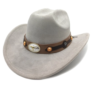 Detail of grey suede cowboy hat featuring brown leather band with silver bull head and stars