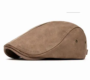Detail view of khaki flat cap showing breathable metal eyelets and fine stitching