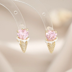 Macro shot of ice cream cone stud earrings with pink heart zircon and gold detailing