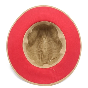 Detail view of woven straw hat interior featuring red inner brim and adjustable sweatband