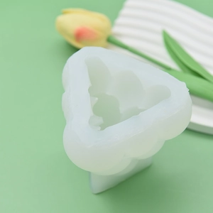 Translucent rabbit shaped silicone mold for DIY candles on a green background