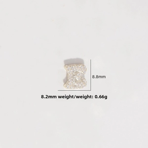 Detailed macro view of S925 silver letter E charm with sparkling pavé cubic zirconia