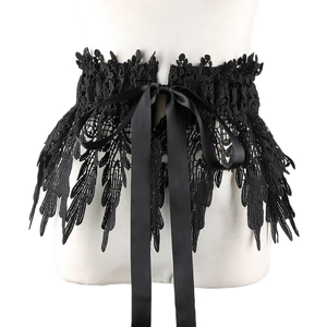 Detailed view of black lace corset belt with a satin bow and intricate embroidery