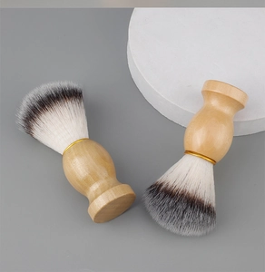 Detail of wooden shaving brushes with soft synthetic bristles and gold metal ferrule