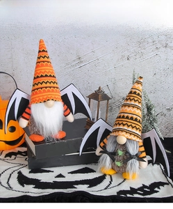 Close-up of Halloween gnome plush dolls with knit hats and black bat wings decorations