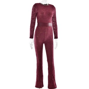 Detailed macro view of the wine red floral lace fabric and waistband of the bodysuit
