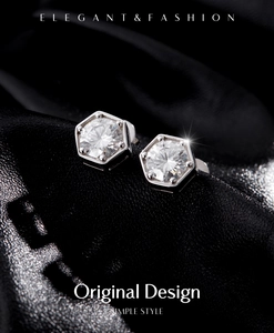 Macro shot of 1 carat moissanite stud earrings in a hexagonal silver setting on black silk