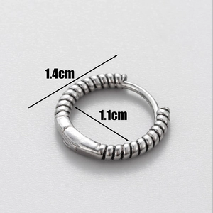 Detailed macro view of retro silver skull earring with 1.4cm outer diameter measurements