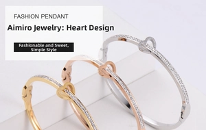 Detail of three-color titanium steel heart bangles with zircons and Love Forever engraving