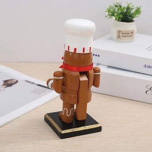 Rear view of gingerbread nutcracker showing the classic mechanical wood structure and chef hat