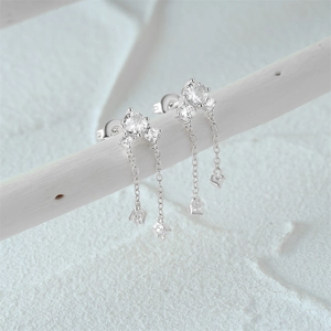 Detailed macro view of S925 sterling silver tassel earrings with sparkling clear crystals