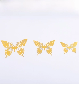 Detail showing 3D hollow butterfly wall stickers in three sizes with gold carving texture