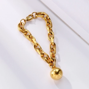 Detailed shot of gold oversized chain bracelet featuring a polished mirror steel ball charm