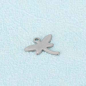 Silver stainless steel dragonfly pendant charm with a polished finish on blue background