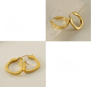 Macro detail of high-polished gold U-shaped earrings with reflective 18K plating texture