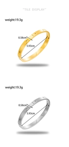Vertical display of gold and silver stainless steel bangles with star pattern engraving