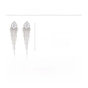 Macro view of long silver tassel earrings showing copper and zircon material details