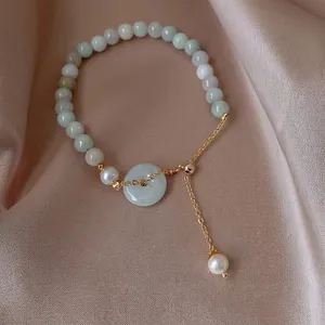 Elegant jade bead bracelet with white pearl and safety buckle pendant on silk
