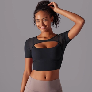 Detail showing breathable mesh sleeves and cutout design on black sports crop top