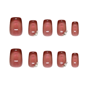 Cat eye wine red press on nails with glitter and rhinestone accents on white background