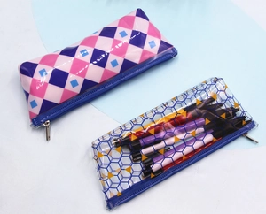 Close-up of PVC pencil cases showing checkered and geometric patterns with blue zippers