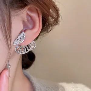 Elegant silver butterfly earrings with sparkling cubic zirconia on female model