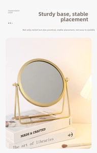 Detail of a round gold vanity mirror showing stable metal base and rotating frame mechanism