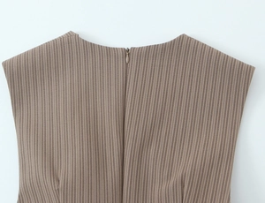 Detail of invisible back zipper closure on brown and white vertical striped dress