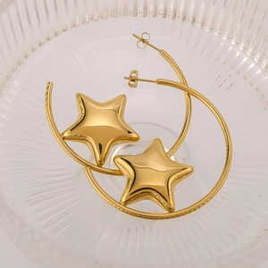 Polished 18k gold plated crescent star hoop earrings displayed on a glass tray