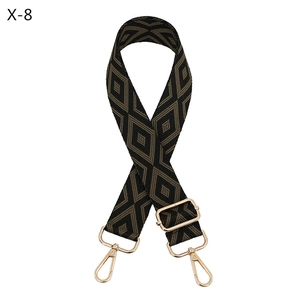 Detail of adjustable rhombus pattern strap with golden metal swivel hooks and buckles