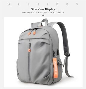 Close-up of water-resistant gray fabric with USB charging port and orange zipper details