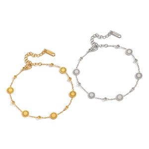 Minimalist stainless steel sun disc bracelet in 18K gold and silver finish on white background