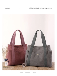 Detail view of canvas tote bags in maroon and charcoal gray with external pockets