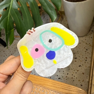 Cute cartoon Westie dog acrylic hair claw clip with colorful patterns in hand