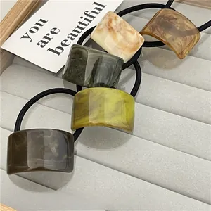 Detailed set of 5 elastic hair ties with marble pattern resin charms in earthy tones