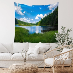 Detail view of large forest nature landscape tapestry over a white sofa in a modern room